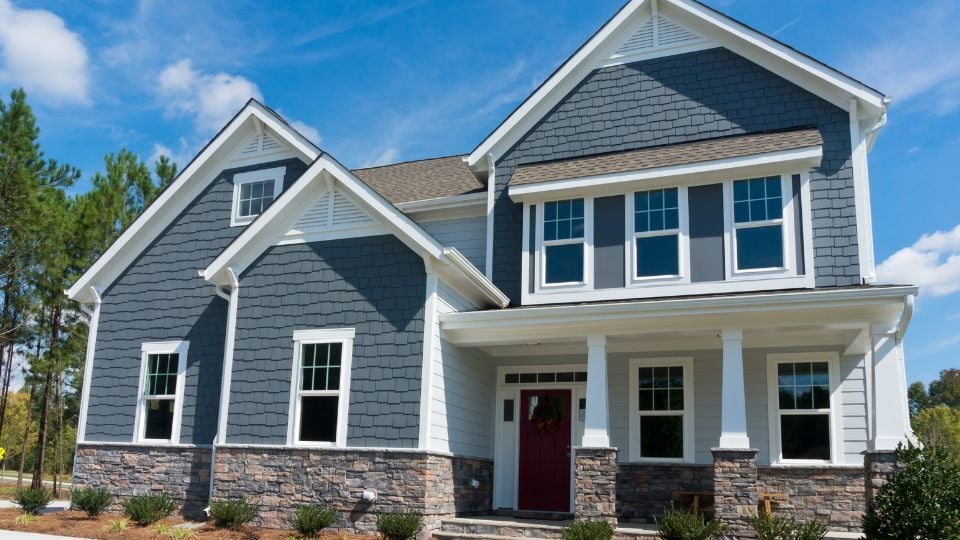 Blue House with Double Hung Windows with Grids on Top